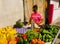 A vendor at an outdoor market in the tropics