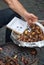 Vendor in Rome offering roasted chestnuts to tourists