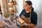 Vendor serving variety of traditional cheese in a cheese farm store