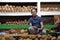 Vendor sits behind a large pile of coconuts in New Market in Kolkata