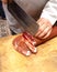 A Vendor slices bacon to his client.