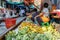 Vendors at famous Maeklong railway market selling fruit and vegetables at railway tracks, Samut Songkhram province, Thailand