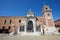 Venetian Arsenal entrance with white statues in Venice, Italy