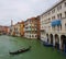 Venetian canal with gondola after the rain, ancient architecture of Italy