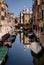 Venetian dreams: evocative image of a quiet canal, traditional houses reflected on the water. Venice, Italy