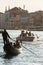 Venetian gondolier riding tourists on gondola at Grand Canal