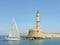 Venetian lighthouse in Chania town and yacht wih people