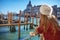 Venetian mask in hand of woman in Venice, Italy