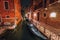 Venezia Italy. Narrow channel and gondola boats in lagoon city venice at night. Long exposure photo