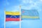 Venezuela and Aruba two flags on flagpoles and blue sky