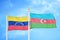 Venezuela and Azerbaijan two flags on flagpoles and blue sky