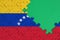 Venezuela flag is depicted on a completed jigsaw puzzle with free green copy space on the right side