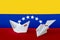 Venezuela flag depicted on paper origami airplane and boat. Handmade arts concept