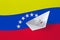 Venezuela flag depicted on paper origami ship closeup. Handmade arts concept