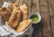 VENEZUELAN COLOMBIAN FOOD. Venezuelan typicals corn empanadas with meat in clay bowl with avocado sauce, Fried empanadas, stuffed