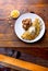 VENEZUELAN FOOD. Corn CACHAPA with cheese and fried pork - cochino frito. Wooden background, top view