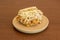 Venezuelan recipe of arepa catira with chicken meat and cheese on a round resin plate
