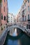 Venice, ancient buildings and calm water in the canal, Italy
