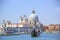 VENICE - AUGUST 27: Gondolier drives a gondola with tourists on board near Santa Maria della Salute on August 27, 2018 in Venice,