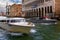 Venice boat transportation, Taxis and tours speed boats in one channel with typical architecture