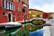 Venice, Burano island, boats on canal and colorful houses