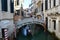 Venice Canal with beautiful bridge and typical venetian construction, houses colored, Venice, Italy summer 2016