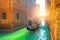 Venice canal, gondola and gondolier with tourists traveling by water in the town