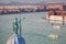 Venice with church against boats on canal in Italy