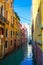 Venice city old narrow canal parked boats and alley Italy