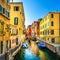 Venice cityscape, buildings, boats, water canal and double bridge. Italy