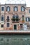 Venice cityscape, narrow water canal, campanile church on background and traditional buildings. Italy, Europe.