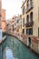 Venice cityscape, narrow water canal, campanile church on background and traditional buildings. Italy, Europe.