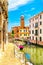 Venice cityscape, water canal, campanile church and traditional