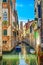 Venice cityscape, water canal, campanile church and traditional buildings. Italy