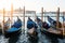 Venice classic sunrise view with gondolas on the waves