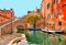 Venice colorful corners, old buildings and windows, water canal with boats and small bridge , Italy