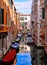 Venice colorful corners, old buildings and windows, water canal with reflections, boats and small bridge , Italy