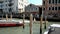 Venice. Elderly man standing in motorboat rides over the channel