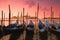 Venice with famous gondolas at gentle pink sunrise light, Italy