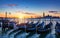 Venice with famous gondolas at sunrise, Italy. Gondolas in lagoon of Venice on sunrise, Italy. Venice with gondolas on Grand