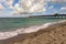 Venice fishing pier in Florida on sunny summer day. Bright seascape with surf waves crashing on sandy beach