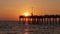 Venice, Florida. Many fishermen tourists enjoying vacation time at sunset on fishing pier. Seaside summer activities