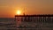 Venice, Florida. People enjoying bright sunset on fishing pier. Seaside summer activities on fresh air