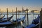 Venice gondola moored with San Marco Maggiore church i