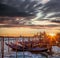 Venice with gondolas against colorful sunset in Italy