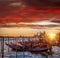 Venice with gondolas against colorful sunset in Italy