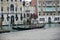 Venice gondolas at rest, behind Rialto market and trattorie, lunchtime, winter