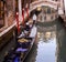 Venice, gondolier with hat, looking down, on cell phone