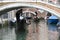 Venice gondoliers approaching a bridge