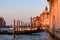 Venice - Group of gondolas moored in Grand Canale during sunset with scenic view of water channel